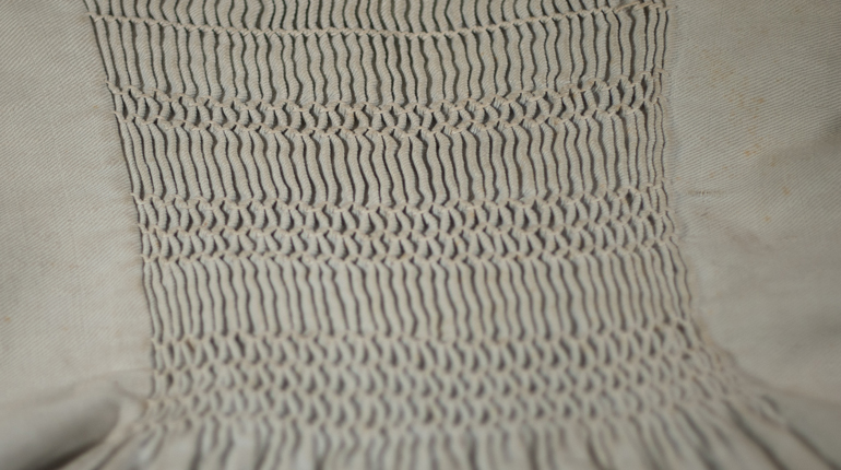 A close-up of smocking stitch on a smock from the MERL collection