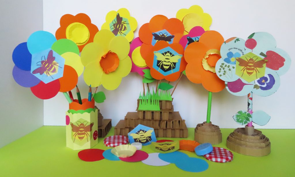 paper bouquets of brightly coloured flowers and bees