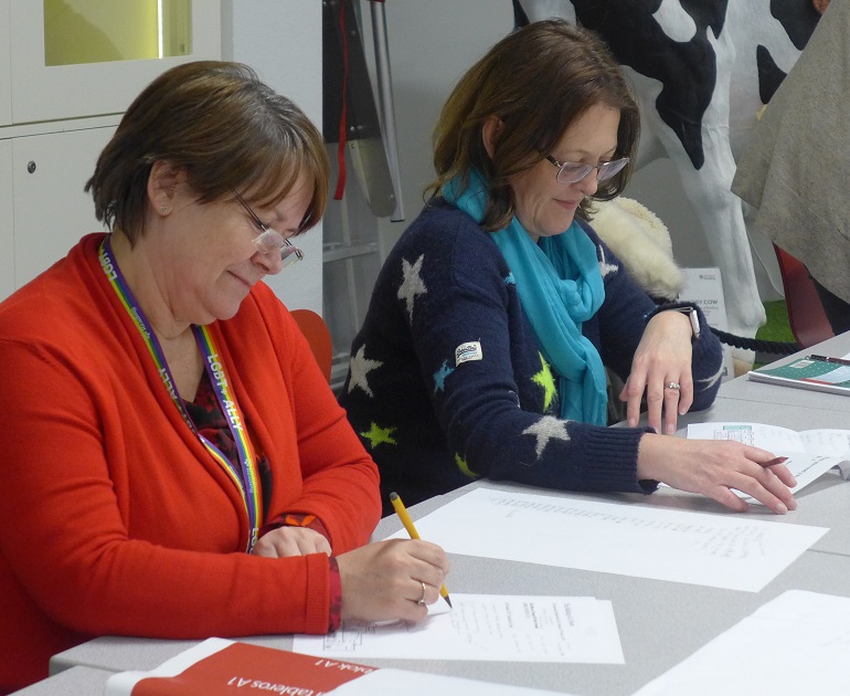 Two women seated at a table in the Learning Studio during one of our forums.