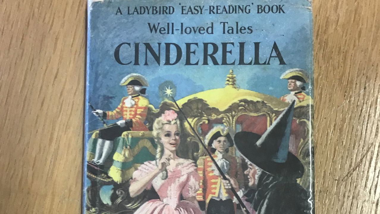Two hands holding the Ladybird Book of Cinderella