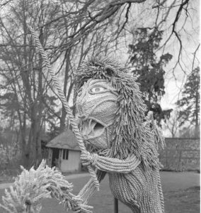 black and white photo of a large straw lion