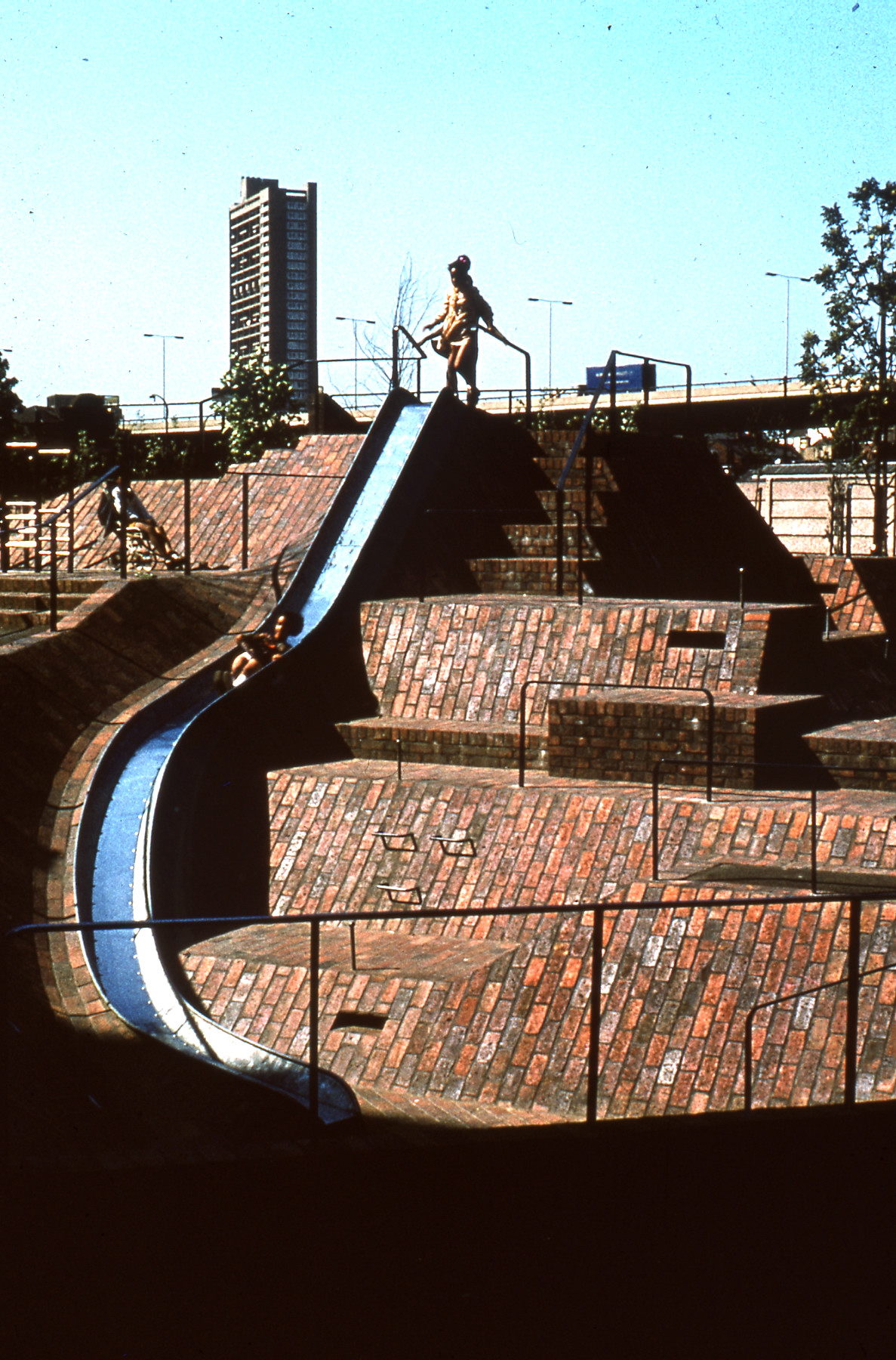 Close up image of multi-level brick surface play area and slide in the Brunel Estate landscape in around 1974
