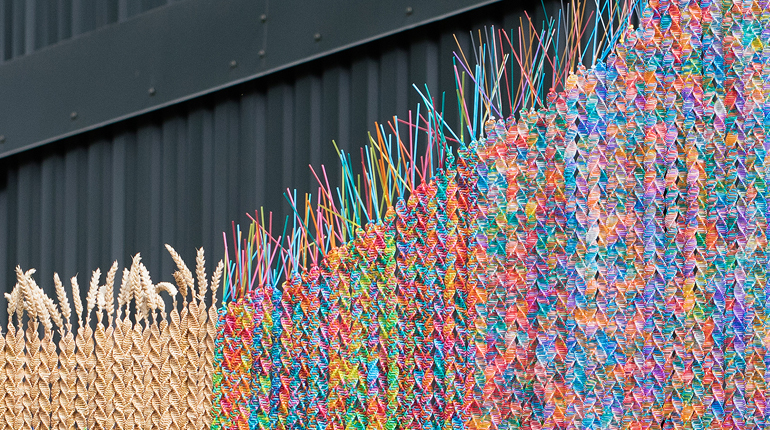 Close up of a Maria McKinney sculpture made from colourful semen straws and straw