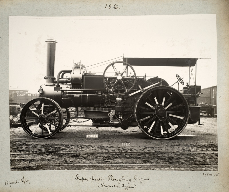 Black and white photograph, showing a side view of a 'Super-heater Ploughing Engine' dated April 15/27. 
