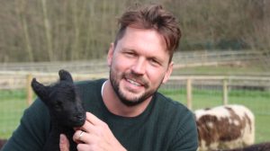 Photo of speaker at the MERL Annual Lecture 2019 Jimmy Doherty, president of the rare breeds survival trust holding a black lamb