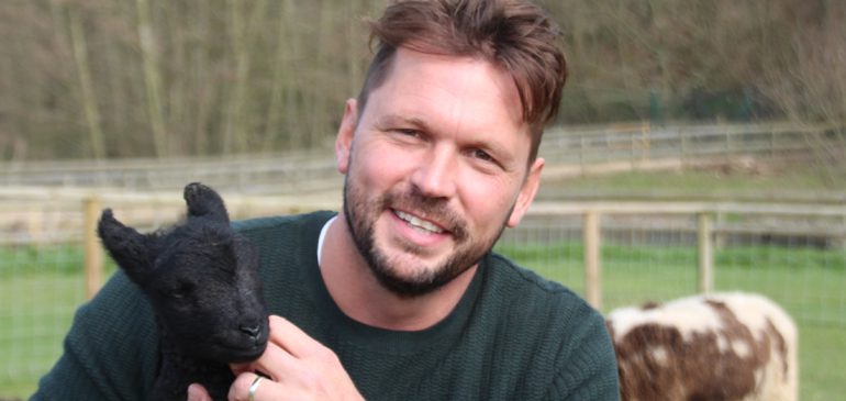 Photo of speaker at the MERL Annual Lecture 2019 Jimmy Doherty, president of the rare breeds survival trust holding a black lamb