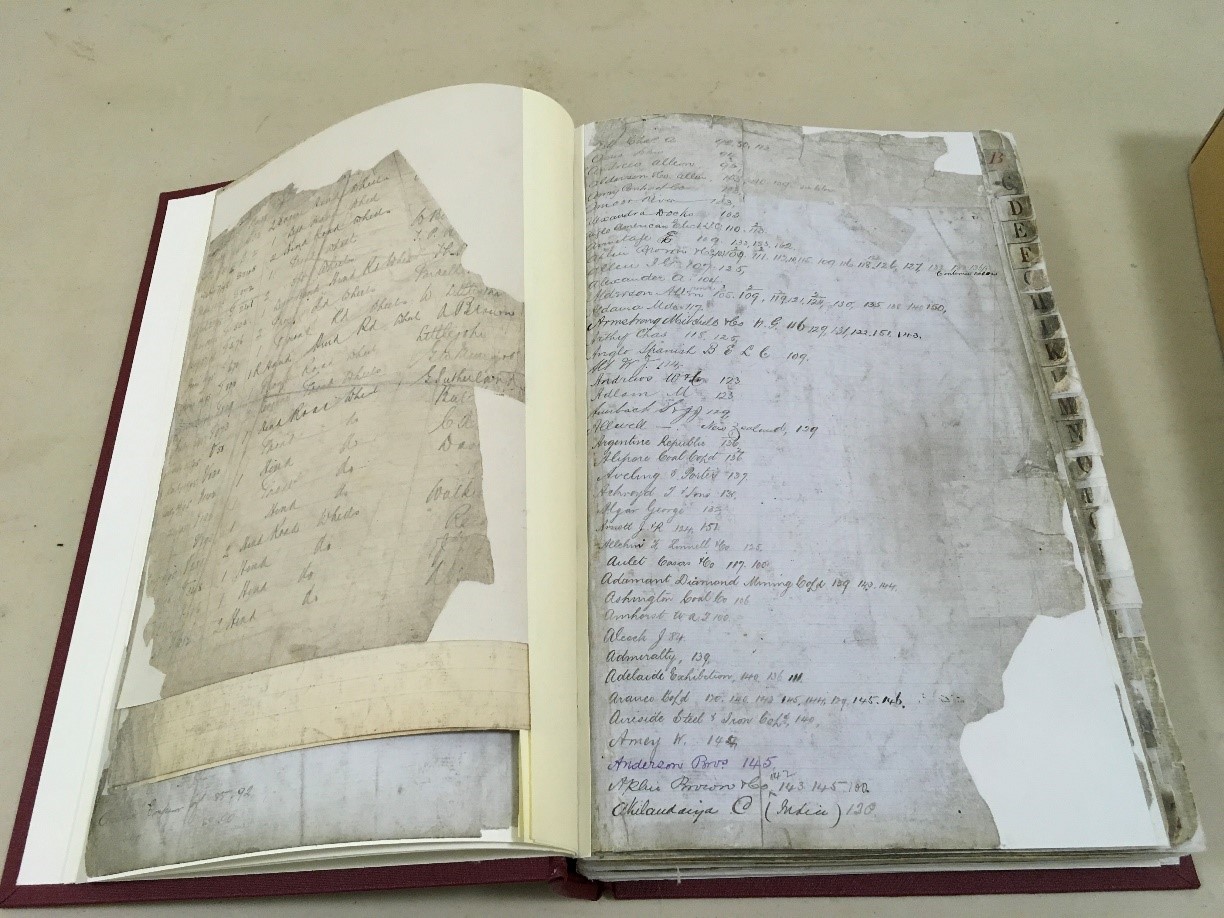 A large ledger in a new red binding, open to a page showing the successful conservation work.
