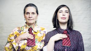 Sheila Ghelani & Sue Palmer wearing brightly coloured shirts and stripy ties which have been cut off, from Common Salt