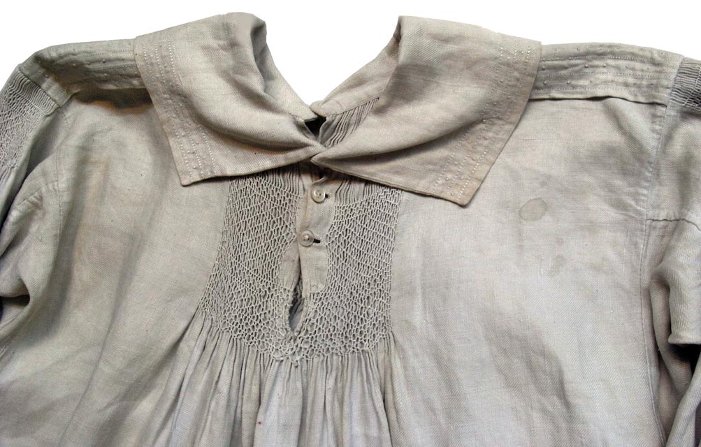 Detail showing smocked panel of front of garment and stains