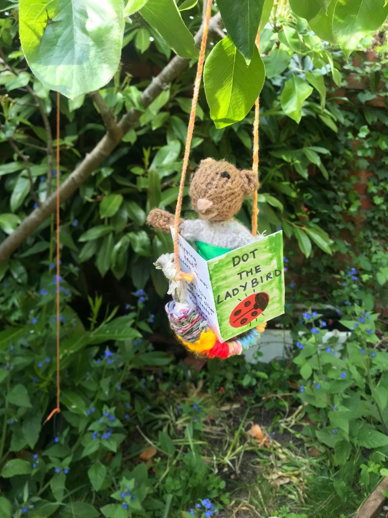 Little Mouse reading a book in Charlotte's garden