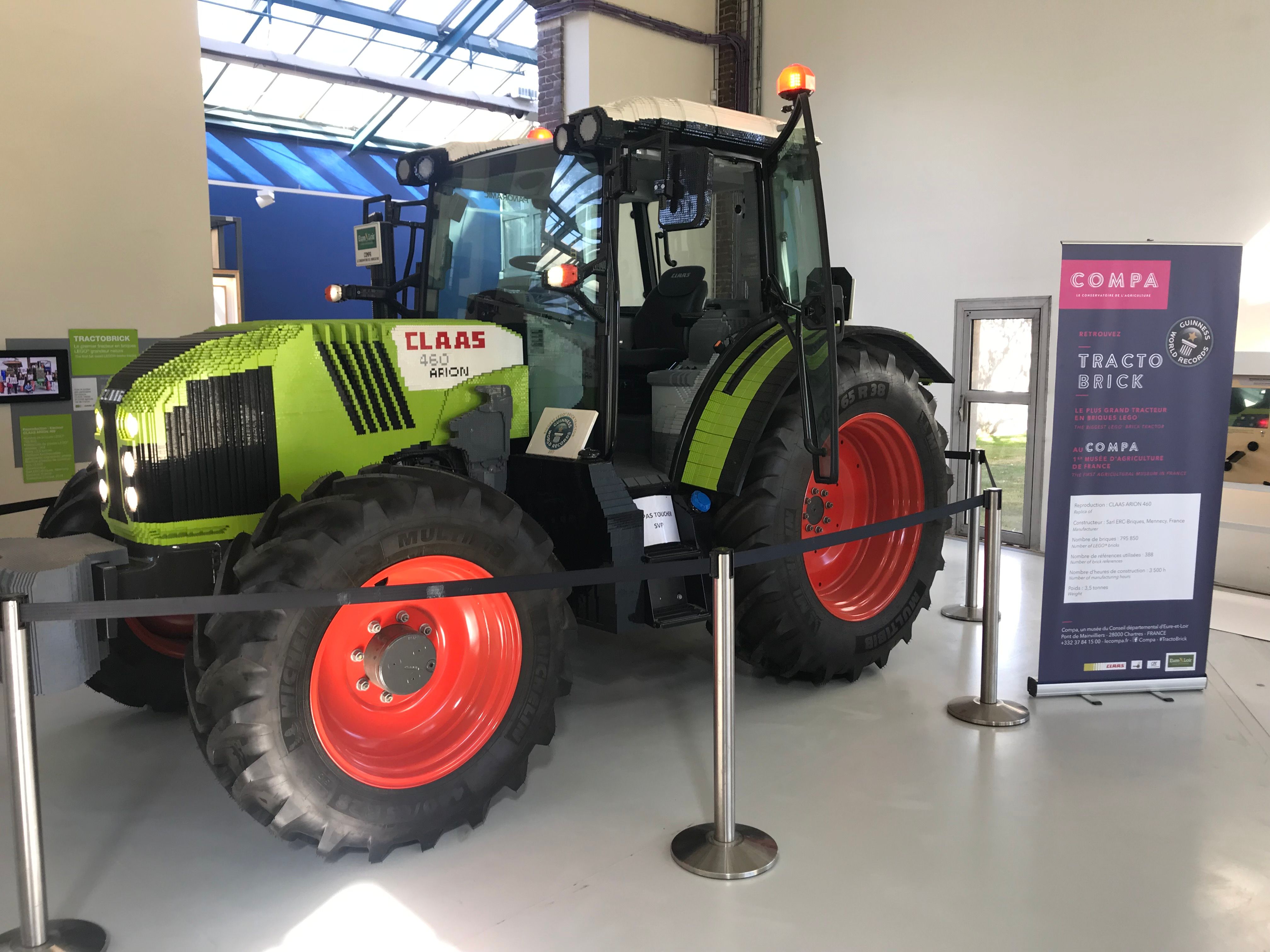 Large green, white and red tractor made of Lego bricks