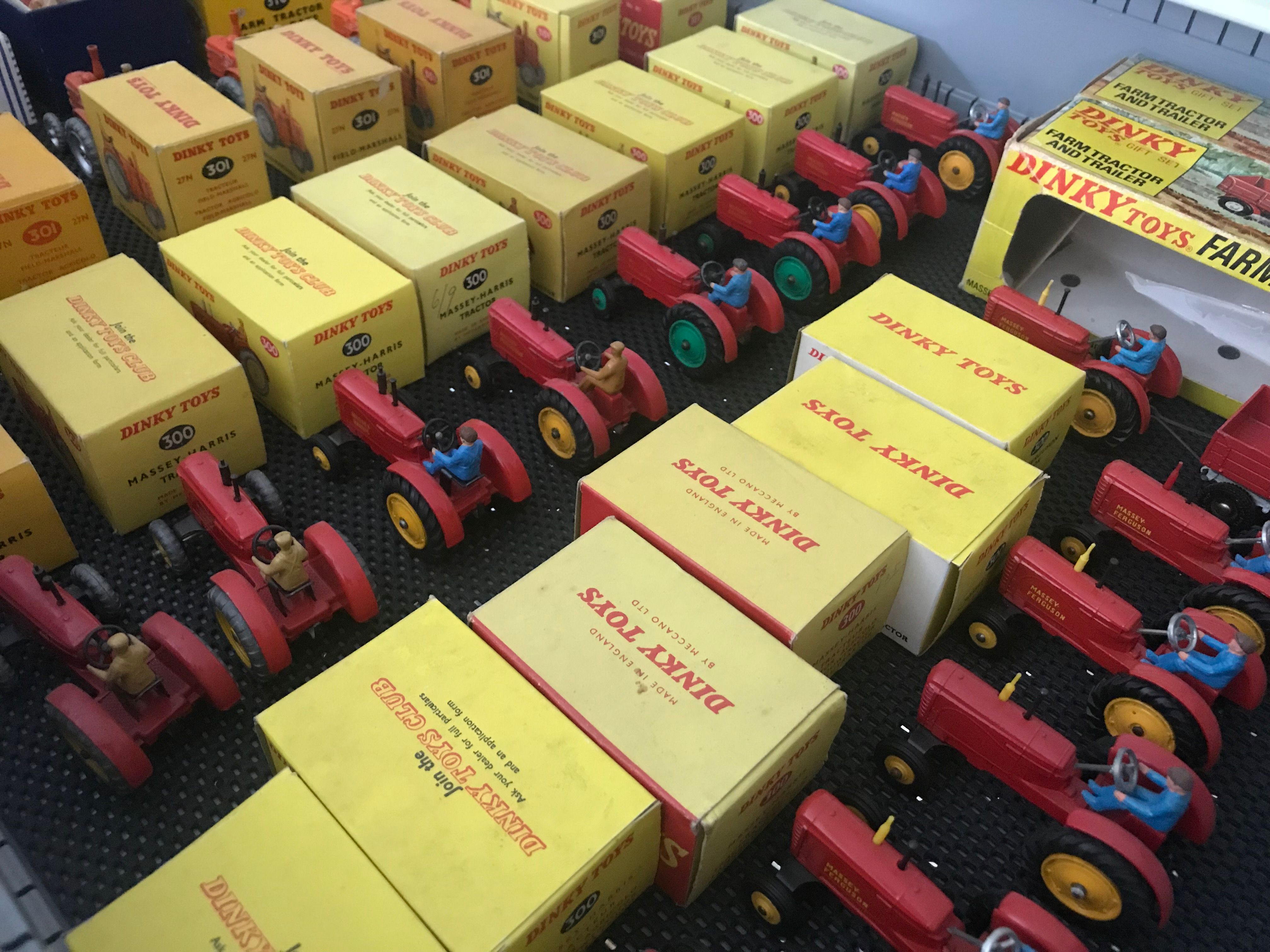 A drawer full of red toy tractors and yellow toy boxes