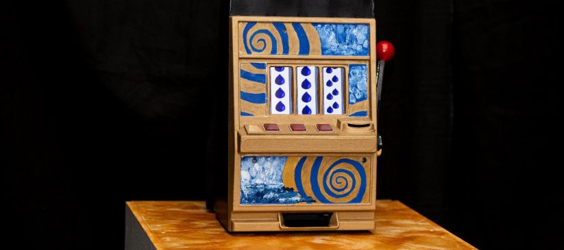 A photograph of the "Gambling with Floods?" installation. It shows a gambling machine that has been customied to demonstrate the complexities of contemporary flood forecasting!