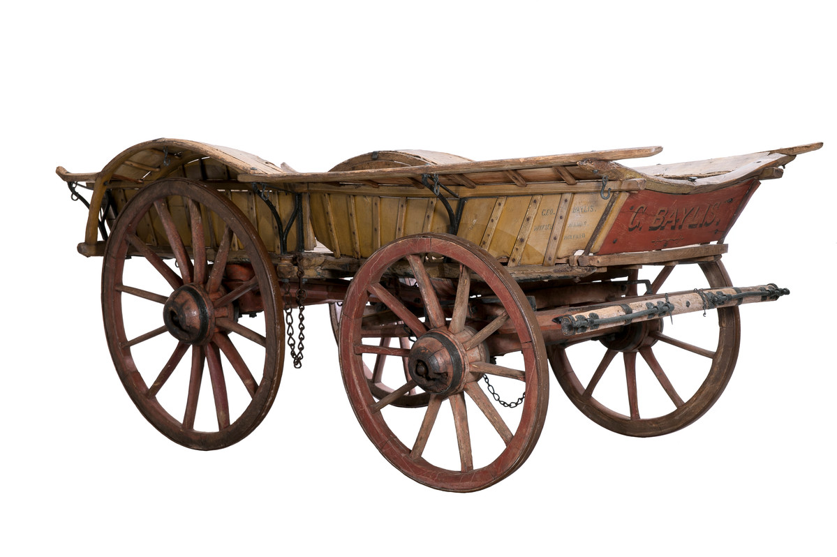 Large red and yellow bow wagon with painted front board reading 'G. Baylis'