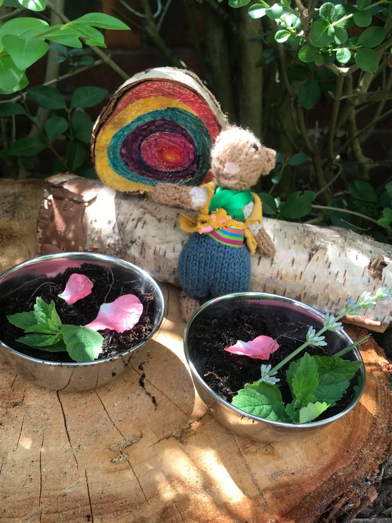 Little Mouse with bowls of mud and a rainbow pebble