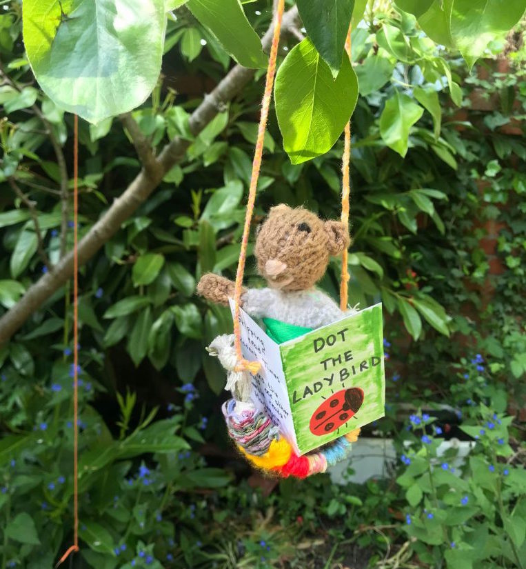 Little Mouse reading a book in Charlotte's garden