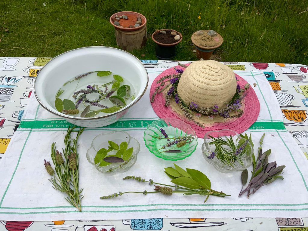 Scent bowls on a table, with mud, sand and water stations in the background