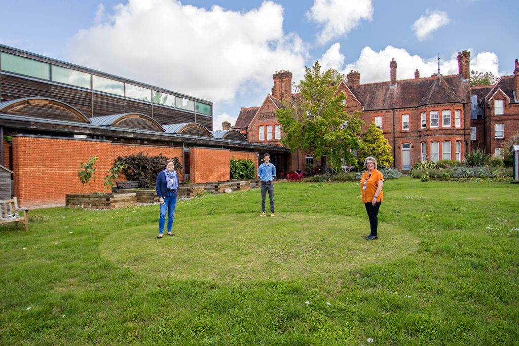 Our front of house team demonstrate the garden's new soccially distanced circles!