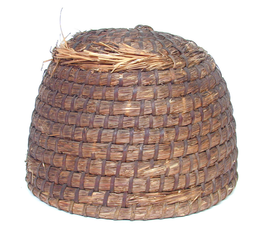 This skep, beekeeping equipment used at Whiteknights House, Reading, is made of coiled straw and is bound with bramble strip. It was probably made in the early twentieth century, and was in use at Whiteknights House from about 1914.
