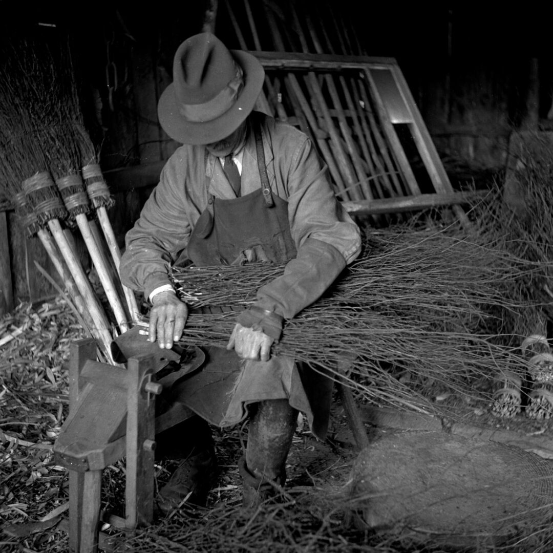 A craftsman making a besom broomstick. (MERL PH1/45)