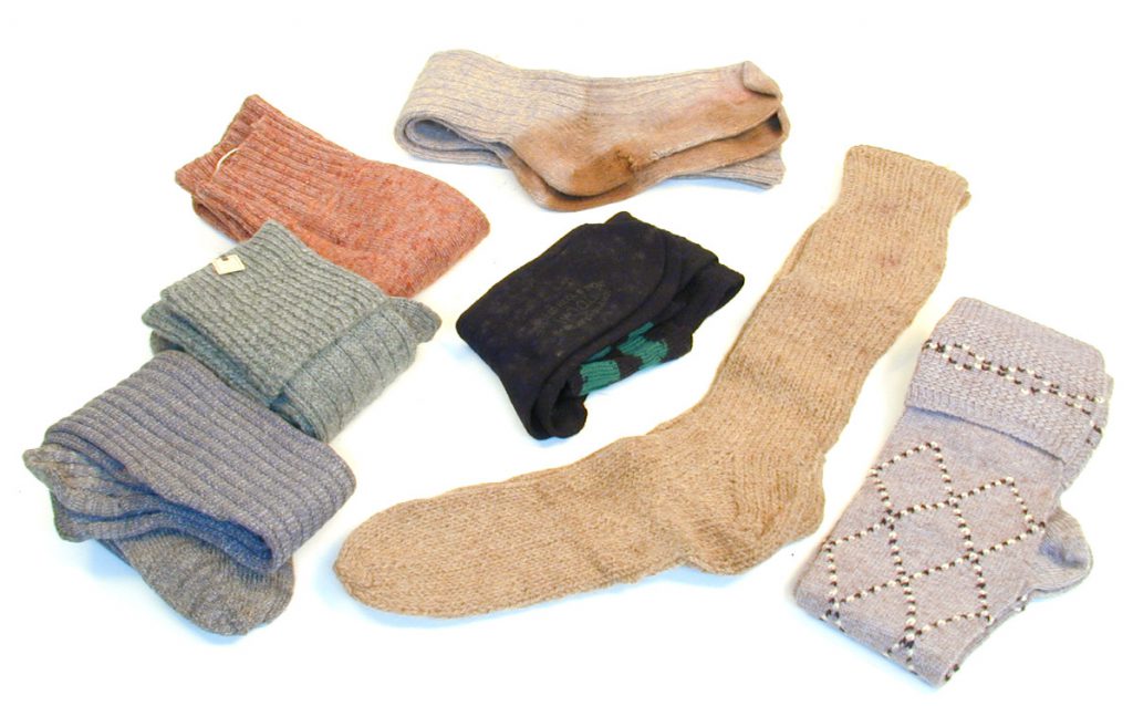 These are seven pairs of men's long socks of various colours and designs.The two pairs are machine knitted and the five pairs are probably hand knitted. The MERL collection: socking it to them since 1951.
