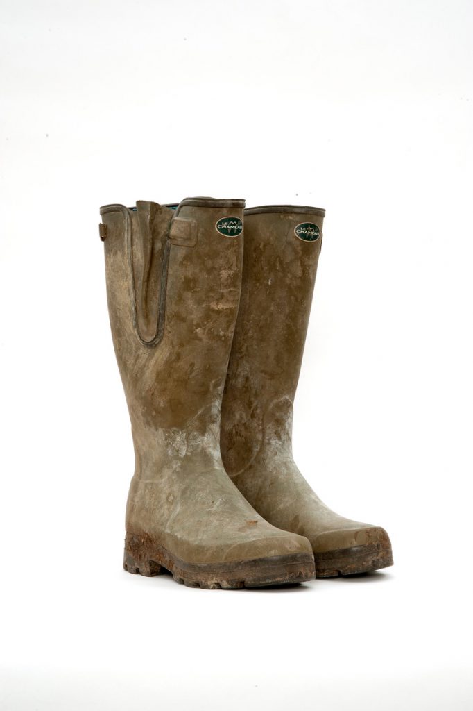 A pair of muddy green wellington boots