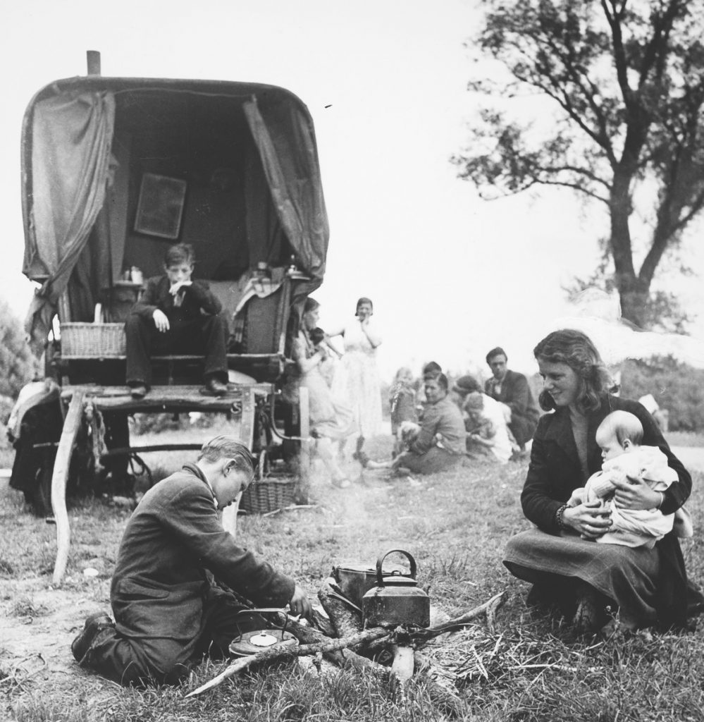 Black and white photograph of a family of gypsies taken by John Tarlton in Essex, likely in the 1950s.