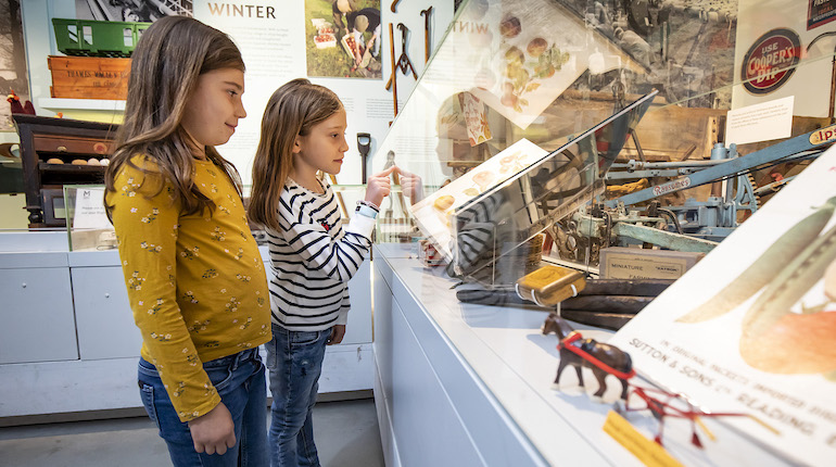Two children looking into a display case in the MERL galleries