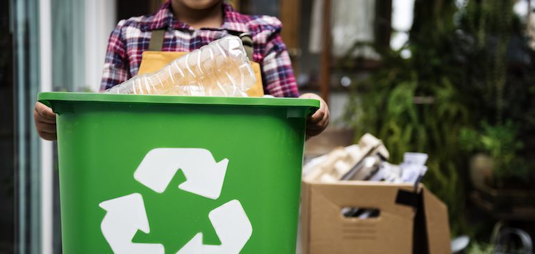 Child carrying a recycling bin