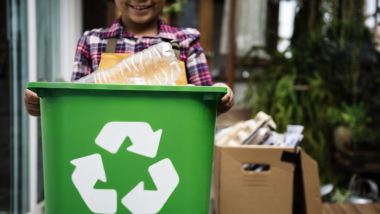 Child carrying a recycling bin
