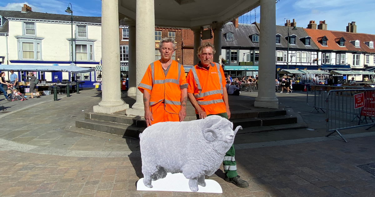 Two workmen pose by the absolute unit in Beverley Market.