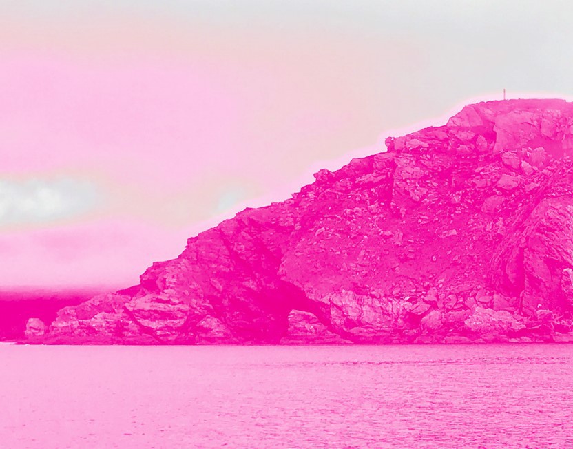 Pink photograph of a hill and lake