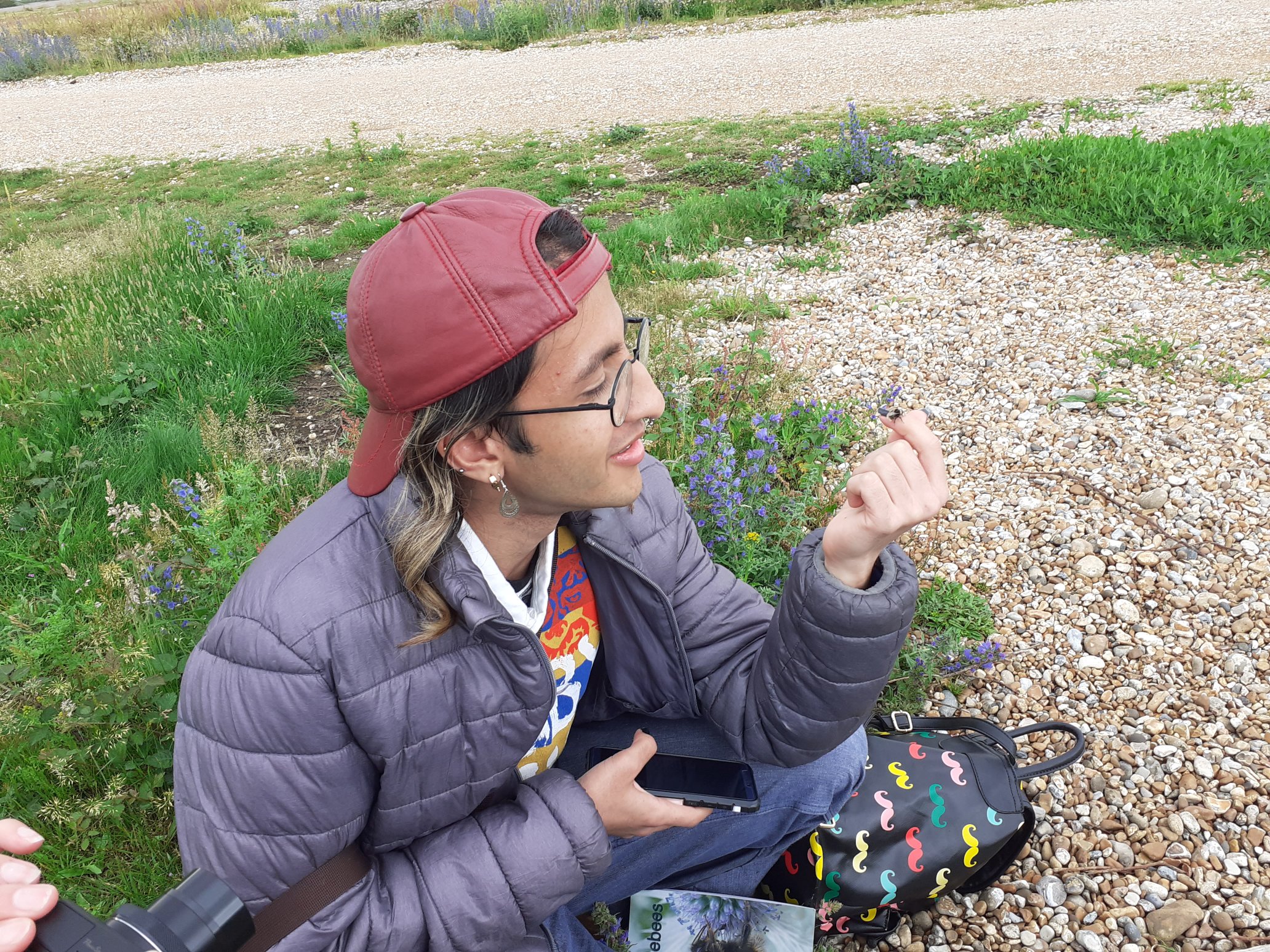 This photo was taken at RSPB Dungeness, when Dawood met up with someone from the Bumblebee Conservation Trust. Together they explored the bees living in the reserve. Notice the one on Dawood's finger!