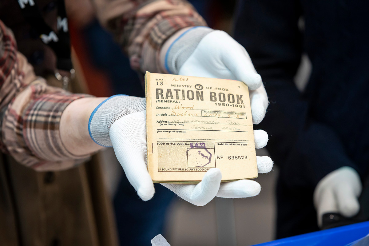 A member of The MERL team holds a ration book.