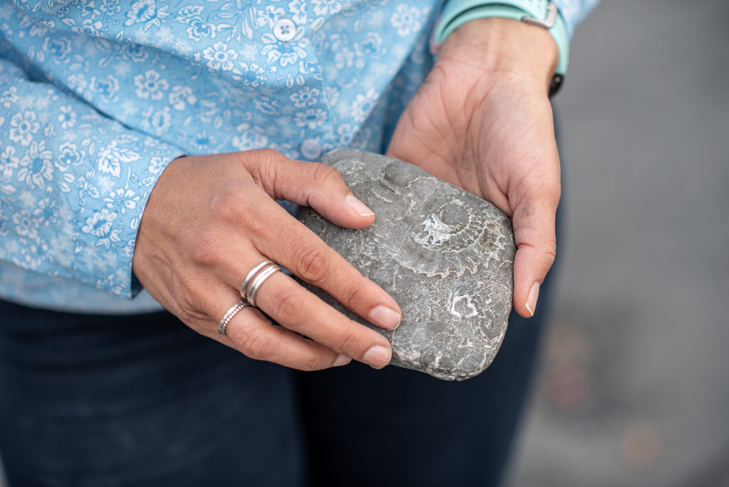 Close-up on Dr Anjana holding a stone.