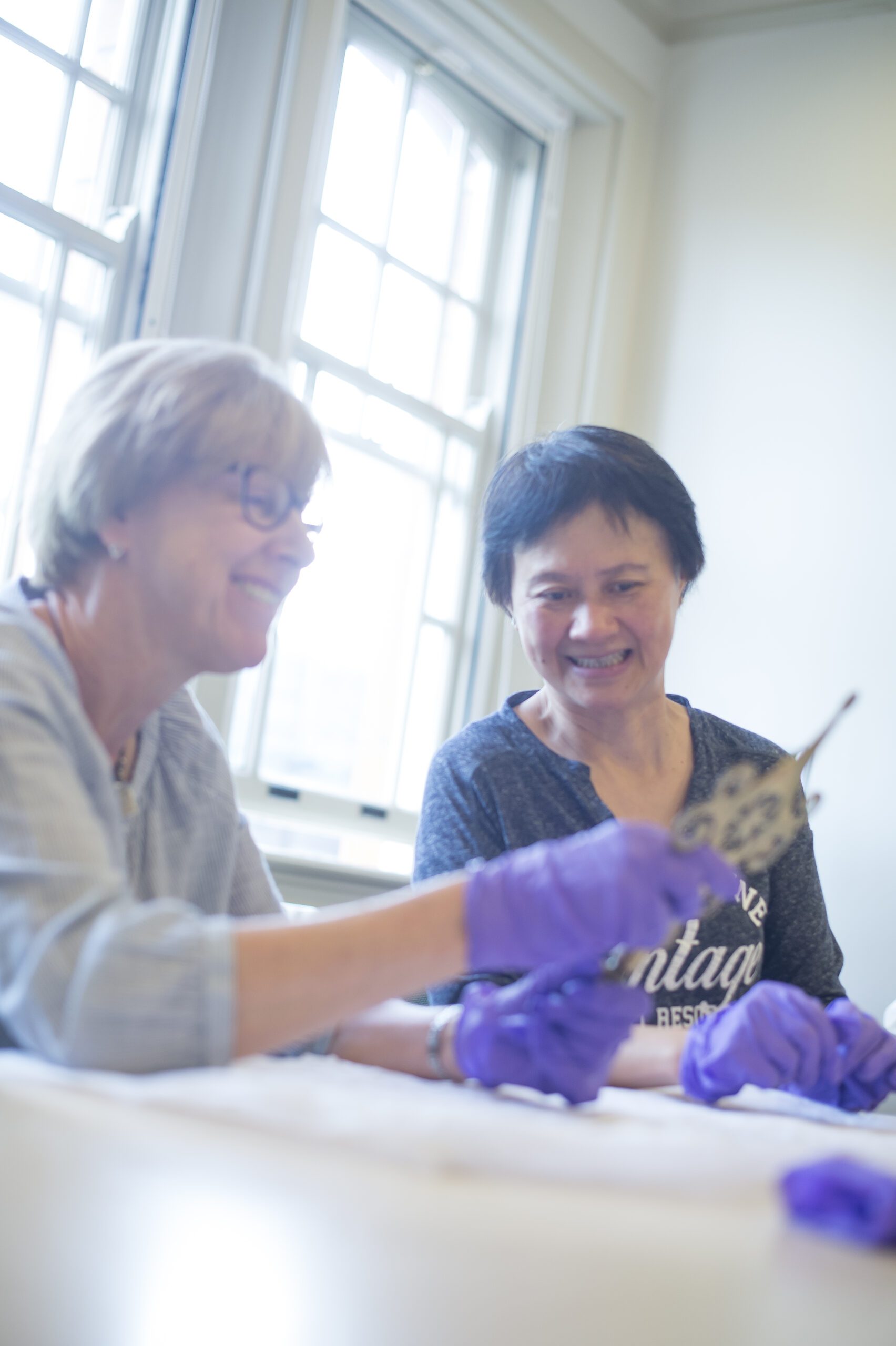 A volunteer runs an object handling session.