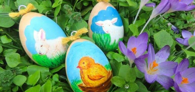 Painted Easter eggs sitting in grass and flowers