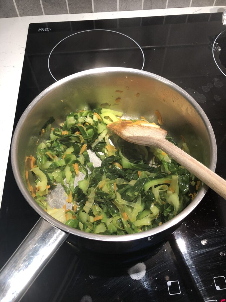 Soup being cooked in a pan.