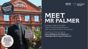 A man dressed as a Victorian Mr Palmer holding a biscuit tin standing in front of the Huntley & Palmers building in Reading