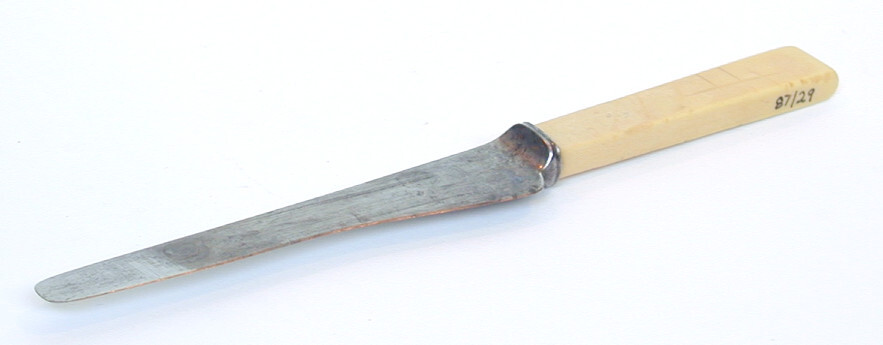 This is a knife with a steel blade and a handle possibly made from bone. The blade is very worn from use and regular sharpening.