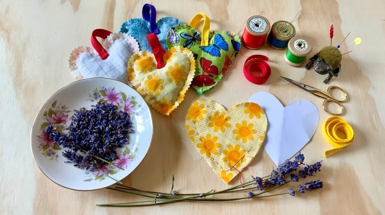 Craft materials and lavender lying on a table.