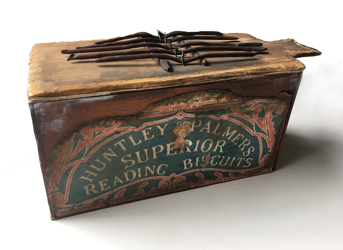 A musical instrument made from a Huntley & Palmers tin.