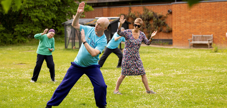 People taking part in a Tai Chi session in The MERL garden
