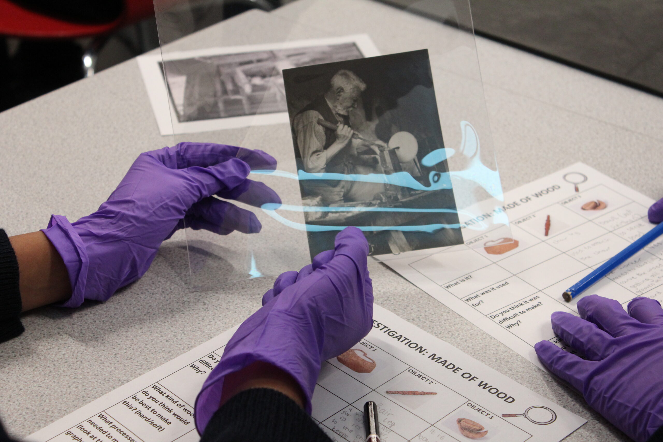 Two people look at objects in The MERL collection.