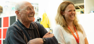 Two people laughing in one of the museum spaces.