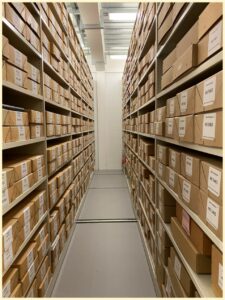 An image showing roller racking on either side housing one of the Special Collections, stored on 108 shelves, in 864 boxes.