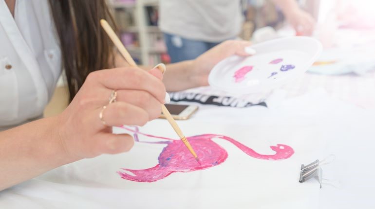 Woman painting a picture of a flamingo