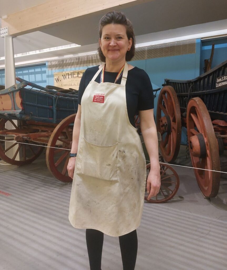 Victoria Stevens ACR wearing a work apron in the MERL galleries