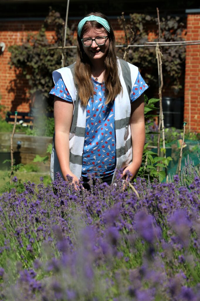Our intern standing behind the lavender bed in The MERL garden.