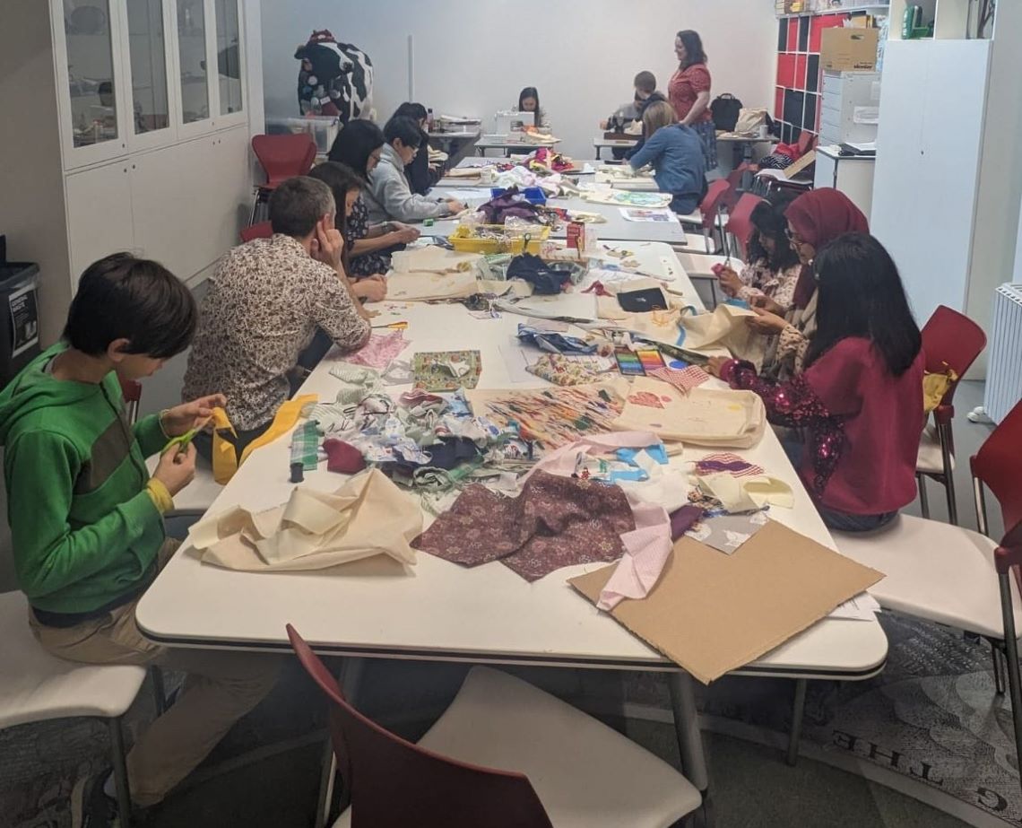 Image of adults and children sewing and crafting